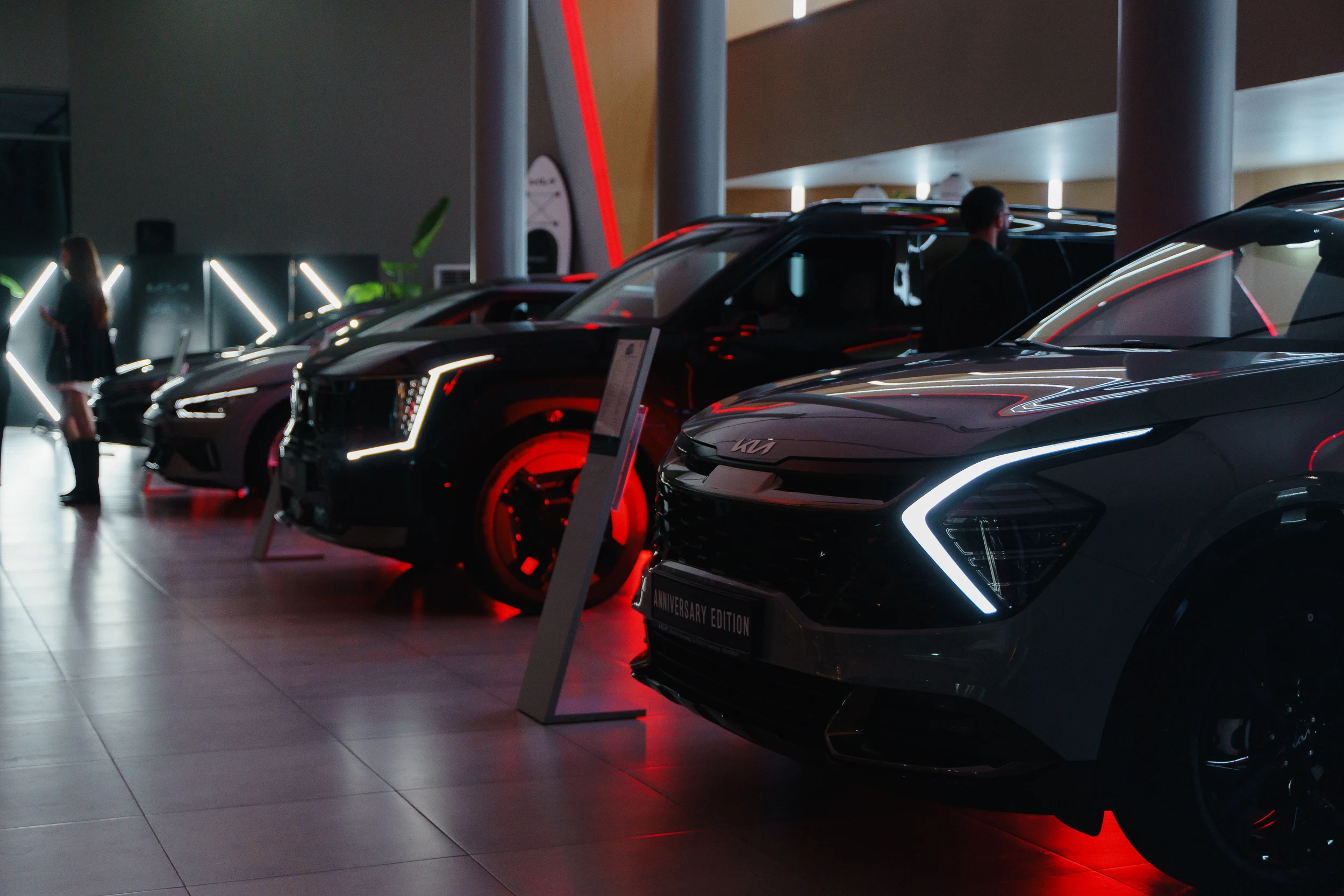 Kia vehicles displayed at a dramatic branded event